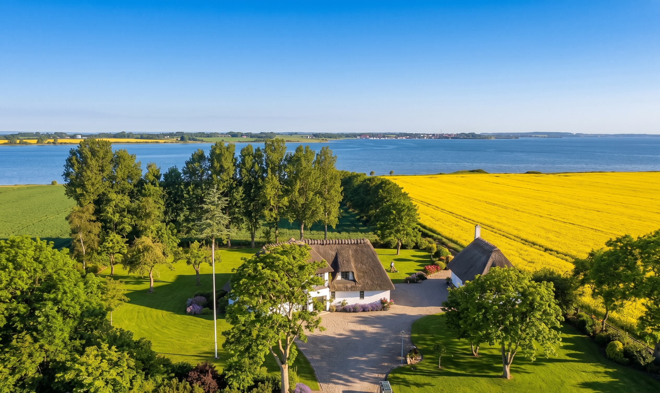 Luftfoto af AlsLeben med stråtækt hus, have og Lillehav