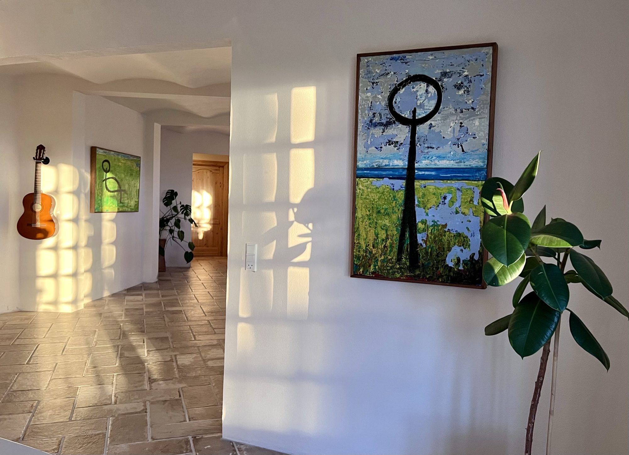 Gang med kunst, guitar og aftenlys i huset